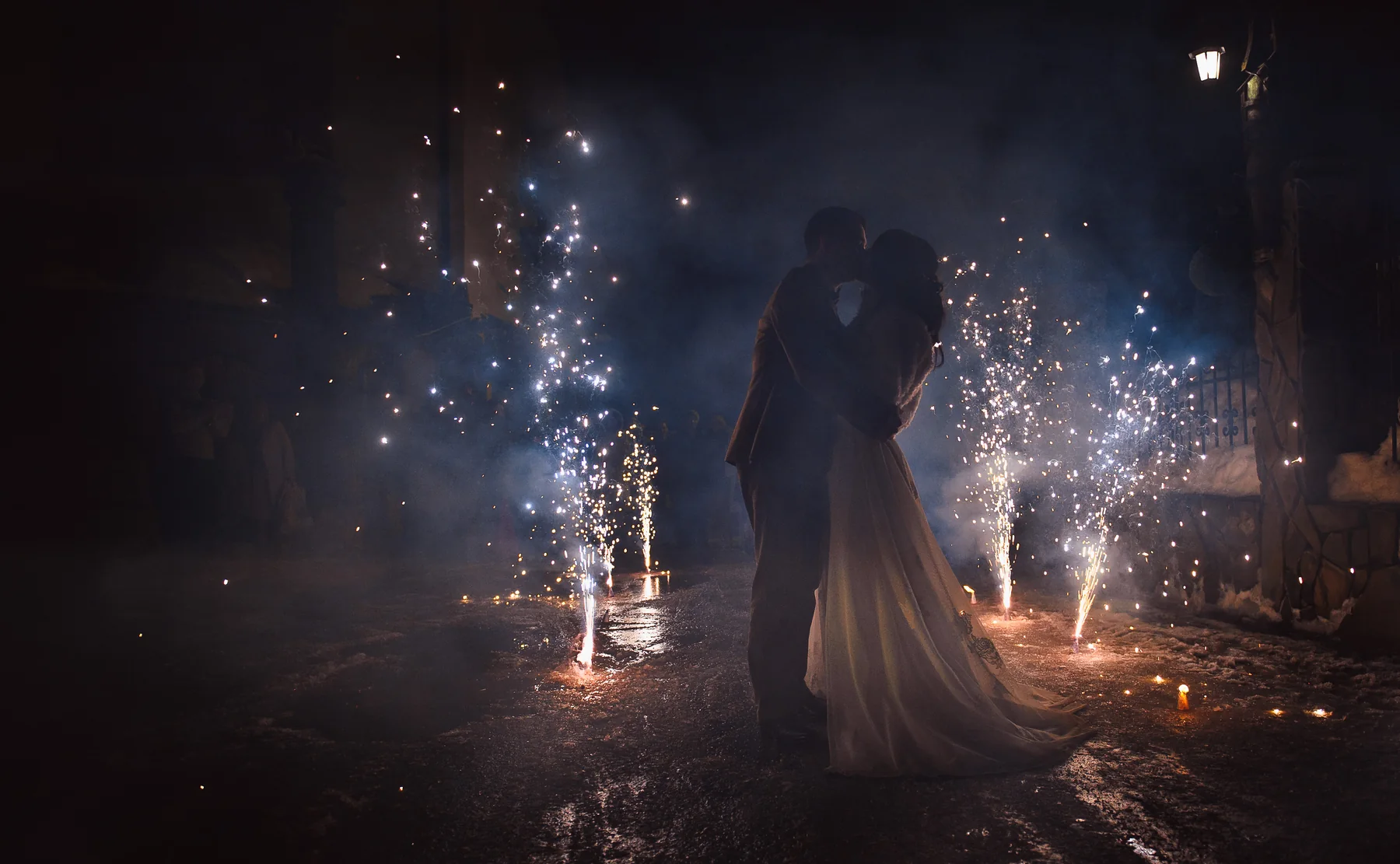 Bride and groom at night with fireworks